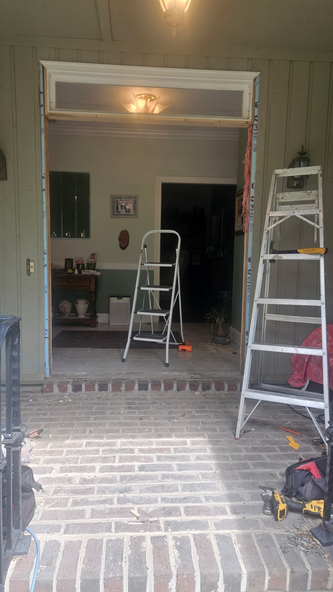Original front entry opening pulled apart down to framing during prep